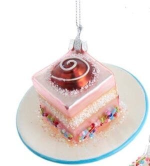 Rosa Tortenstück Weihnachtsornament mit Zuckerdekor.
